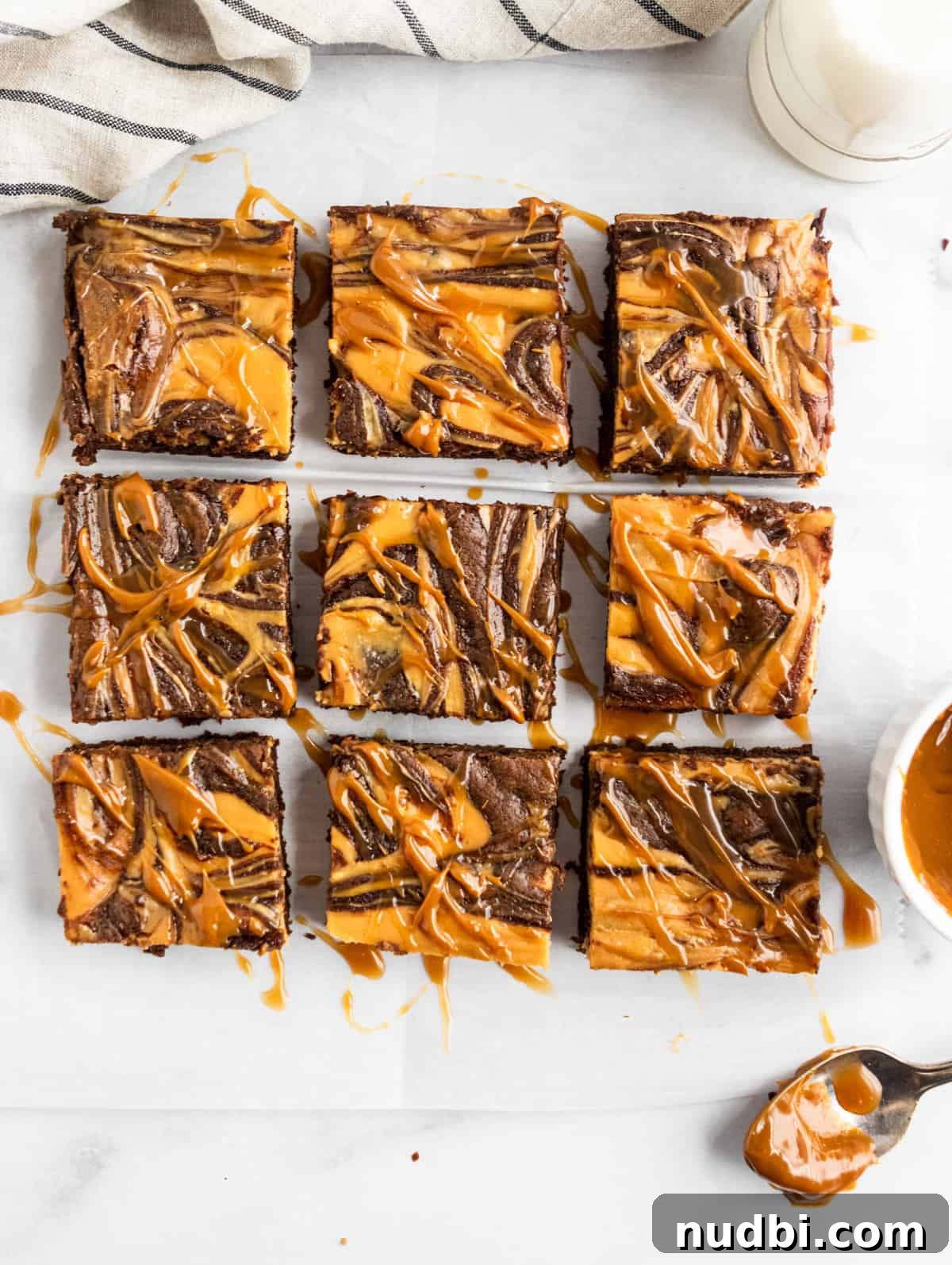 Dulce de Leche Cream Cheese Brownies Recipe for Gooey Bars 3 Overhead shot of sliced brownies with dulce de leche drizzle.