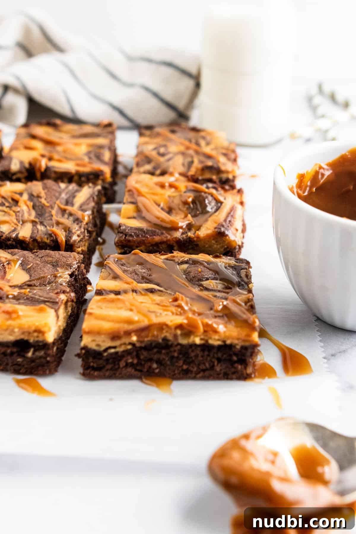 Dulce de Leche Cream Cheese Brownies Recipe for Gooey Bars 4 Sliced brownies with drizzle.