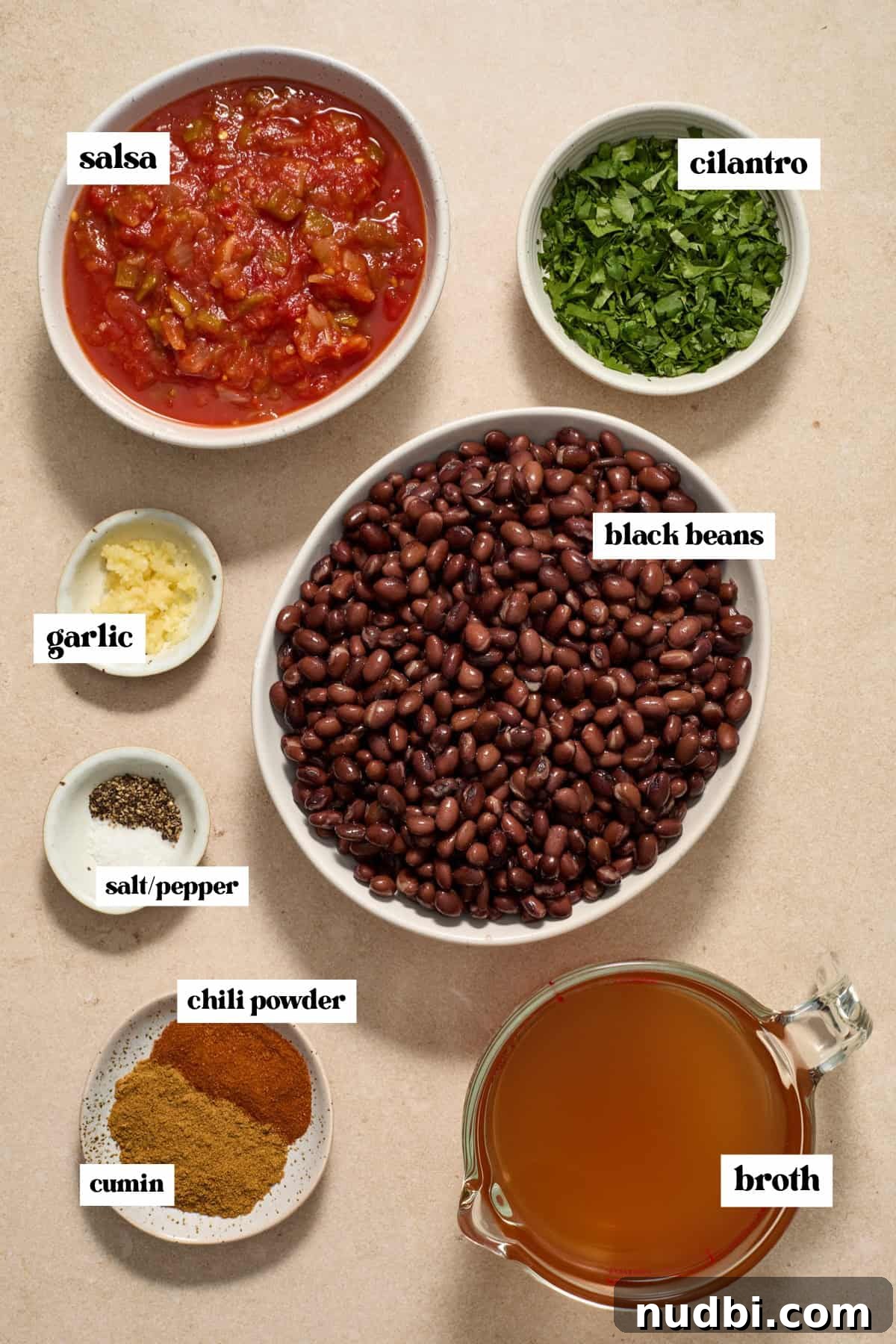 20-Minute Hearty Black Bean Soup Recipe for Weeknight Dinners 3 Beans, cilantro spices and other labeled ingredients on surface.