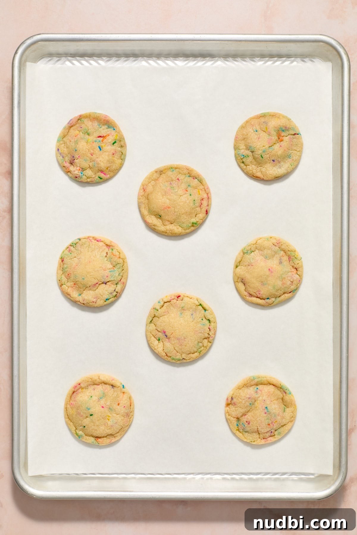 Funfetti Birthday Cake Cookies Recipe for Colorful Party Treats 11 Baked birthday cake cookies on parchment paper lined cookie sheet.