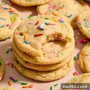 Funfetti Birthday Cake Cookies Recipe for Colorful Party Treats 13 Stack of funfetti rainbow sprinkle filled cookies with bite taken from the cookie on top of stack.