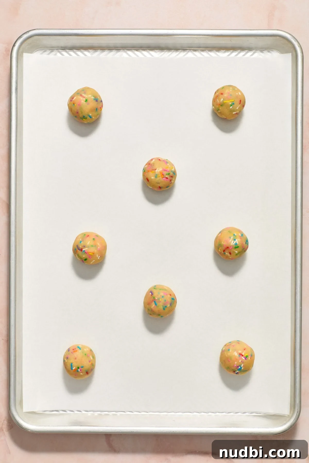 Funfetti Birthday Cake Cookies Recipe for Colorful Party Treats 10 Birthday cake cookie balls on parchment paper lined cookie sheet before baking.