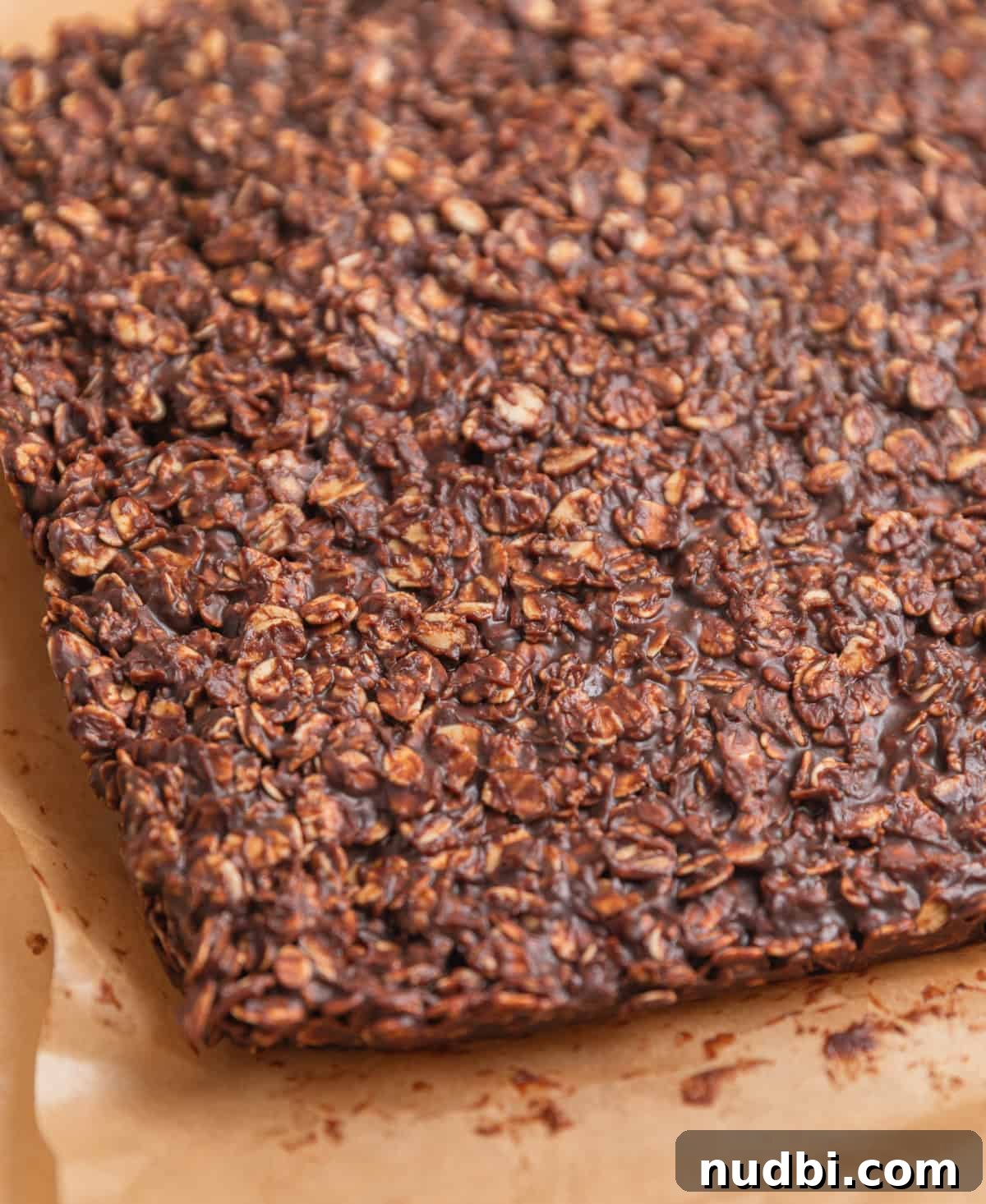 No-Bake Peanut Butter Chocolate Oatmeal Bars Recipe 8 Set peanut butter chocolate oatmeal bars on top of parchment.