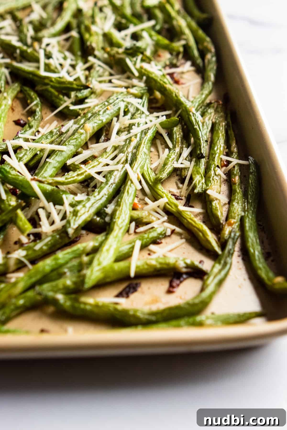 Crispy Roasted Parmesan Green Beans Recipe for Weeknight Dinner 2 Baking sheet with roasted parmesan green beans.