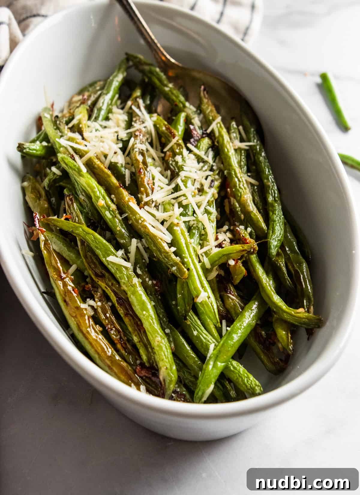 Crispy Roasted Parmesan Green Beans Recipe for Weeknight Dinner 4 White serving bowl with roasted green beans.