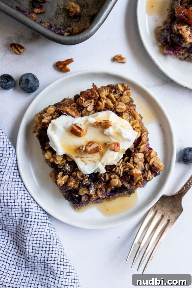 Blueberry Baked Oatmeal Recipe for Cozy Breakfasts 7 Overhead shot of baked blueberry oatmeal with dollop of yogurt.