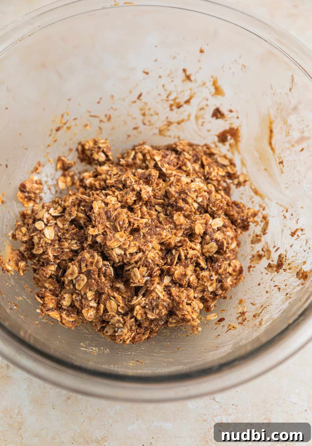 No-Bake Peanut Butter Oatmeal Energy Balls for Quick Snacks 5 Oat and peanut butter ball mixture in glass bowl.