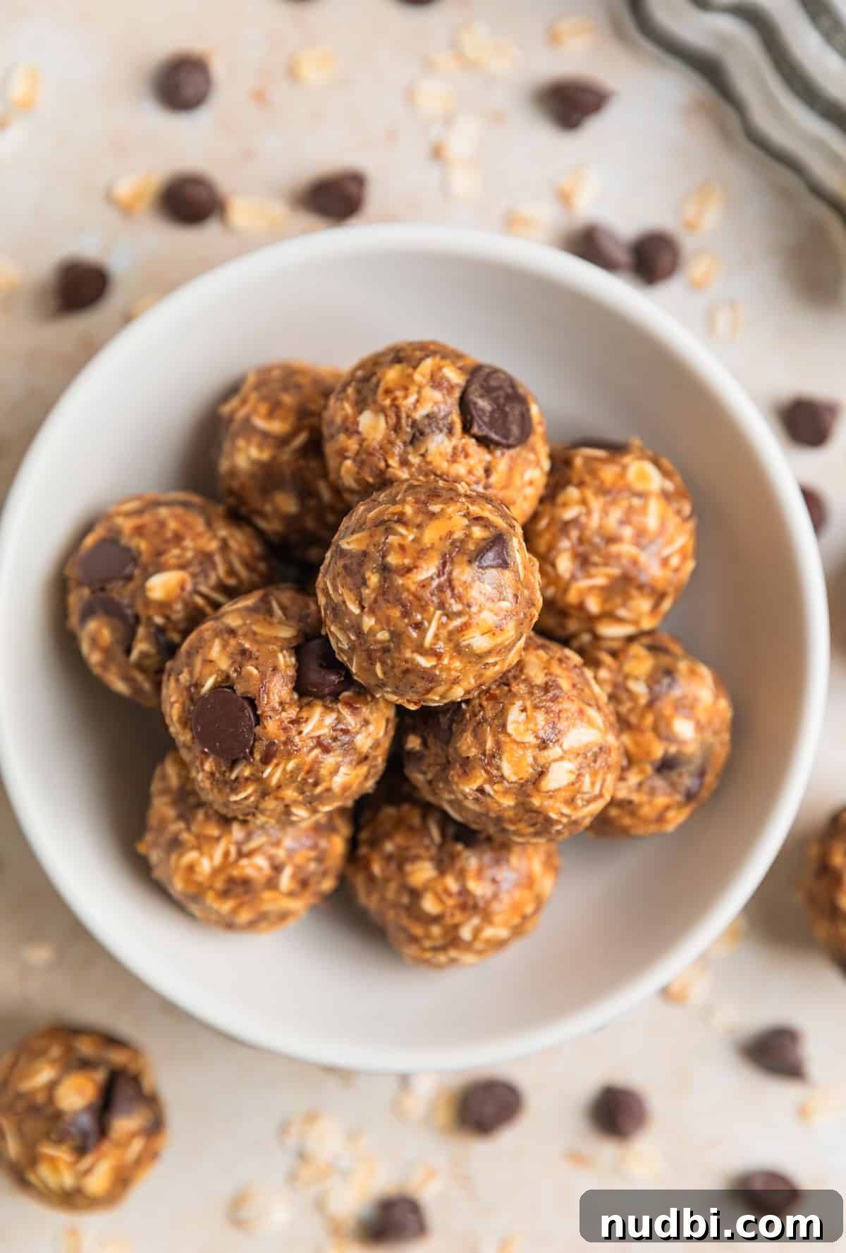 No-Bake Peanut Butter Oatmeal Energy Balls for Quick Snacks 7 Dish with peanut butter oatmeal balls with dark chocolate chips.