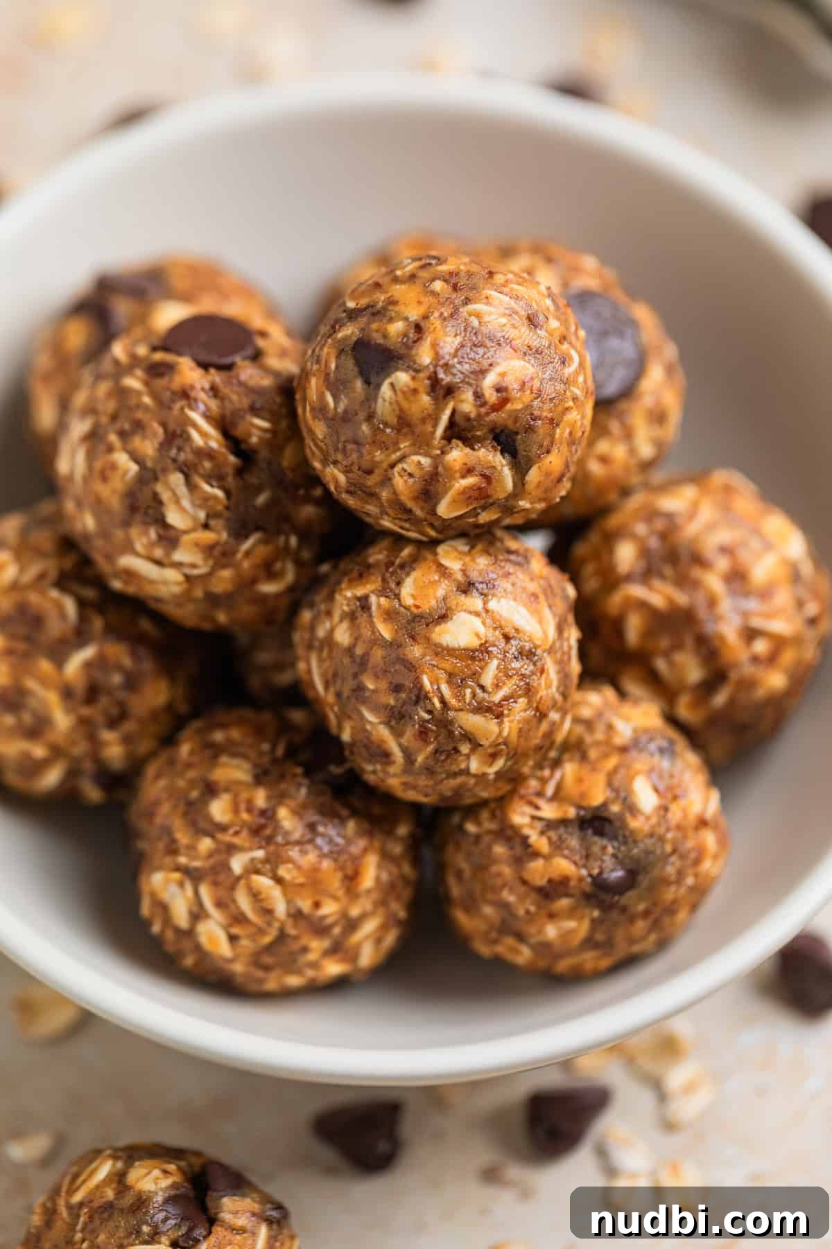 No-Bake Peanut Butter Oatmeal Energy Balls for Quick Snacks 8 Close up view of oat and peanut butter balls in white dish.