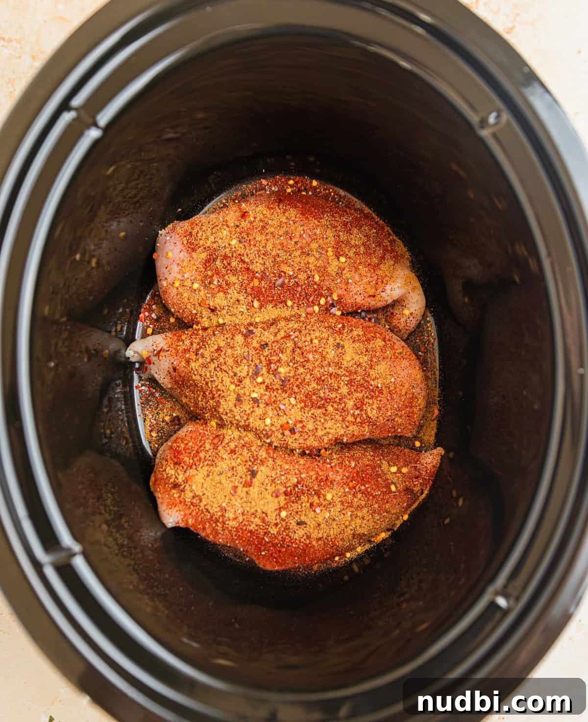 Slow Cooker Chicken Burrito Bowl: Flavorful Make-Ahead Recipe 3 Seasoned chicken breasts in crockpot.