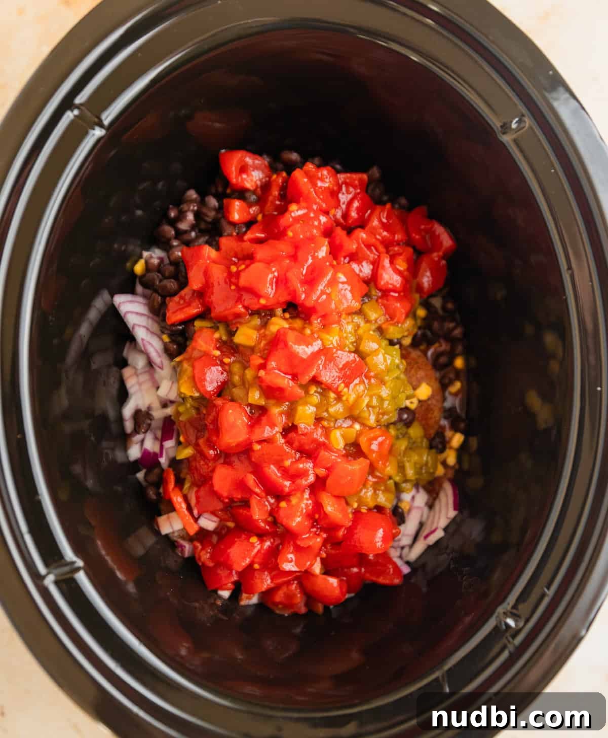 Slow Cooker Chicken Burrito Bowl: Flavorful Make-Ahead Recipe 4 Crockpot with chicken topped with tomatoes, peppers, beans and corn.