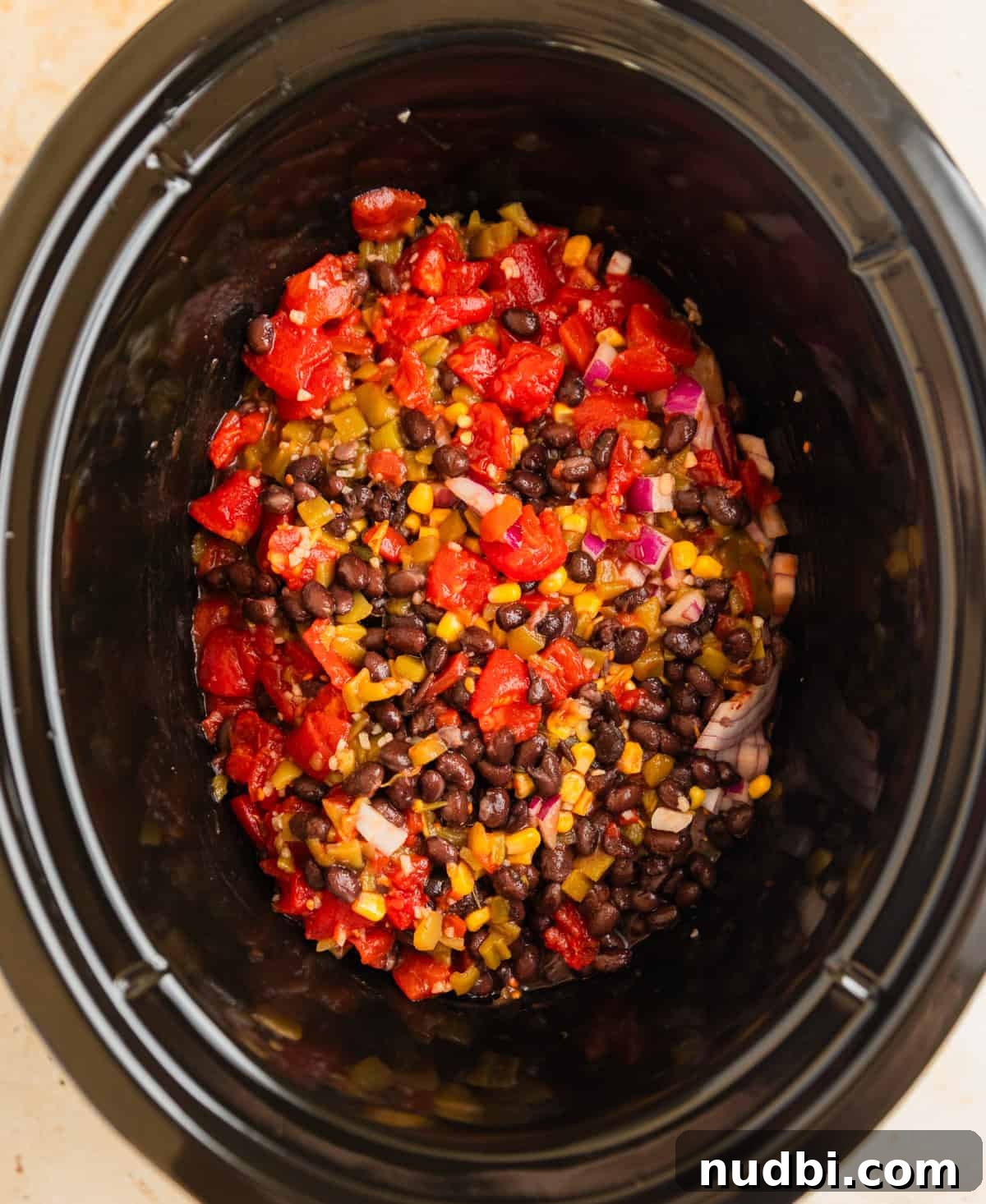Slow Cooker Chicken Burrito Bowl: Flavorful Make-Ahead Recipe 5 Bean, corn and tomatoes over chicken breast in slow cooker.
