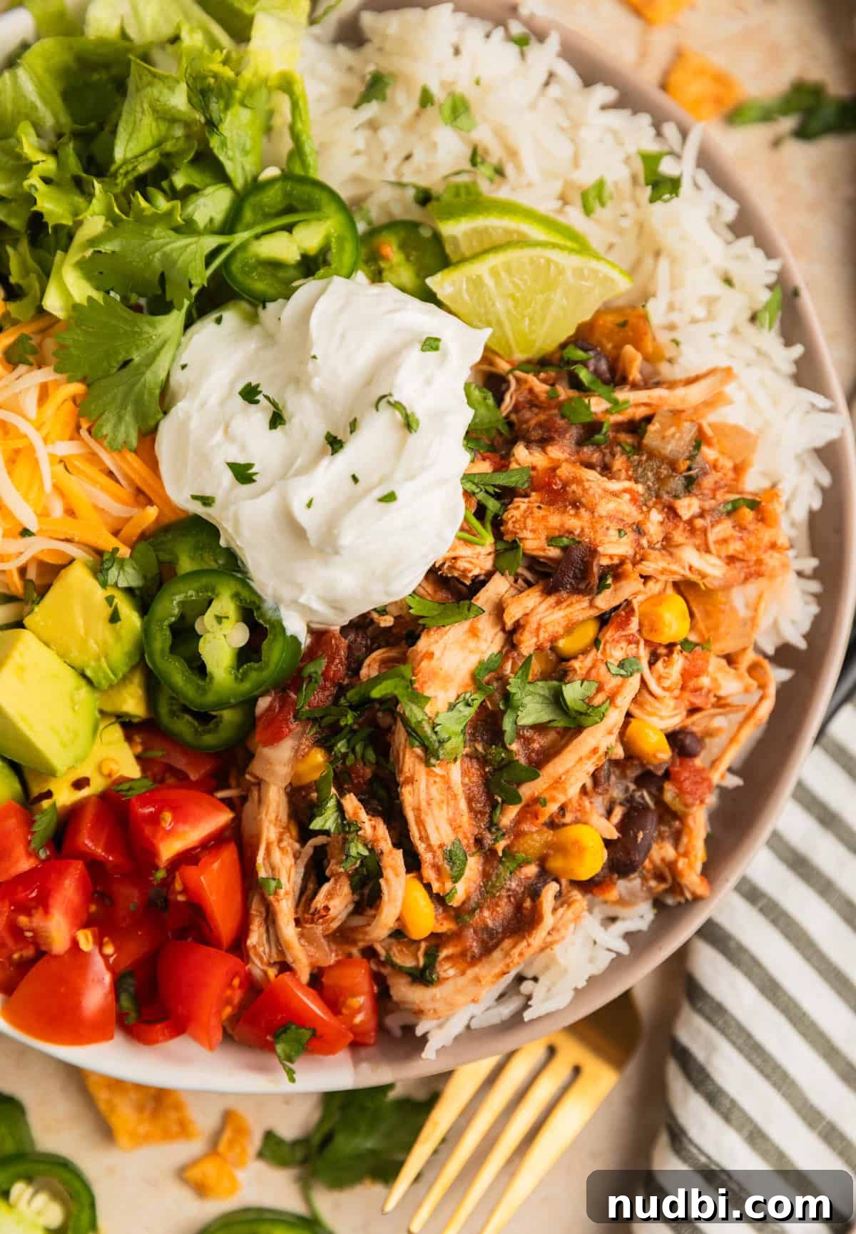 Slow Cooker Chicken Burrito Bowl: Flavorful Make-Ahead Recipe 9 Overhead view of chicken burrito rice bowl with cilantro chopped on top.