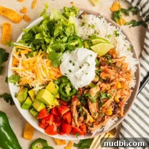 Slow Cooker Chicken Burrito Bowl: Flavorful Make-Ahead Recipe 10 Slow cooker chicken burrito bowl with rice, beans, corn, cheese, lettuce and more.