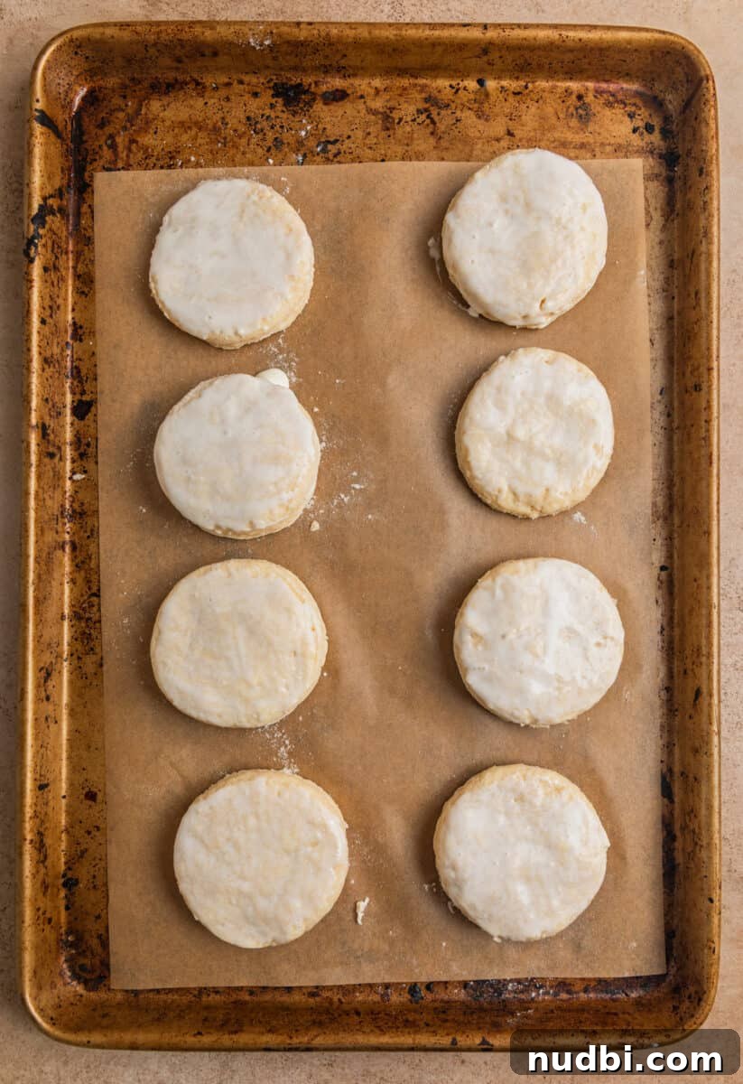 Honey Biscuits Recipe: Soft, Buttery Honey Biscuits in 30 Minutes 9 Cream brushed on top of biscuits lined on prepared baking sheet.