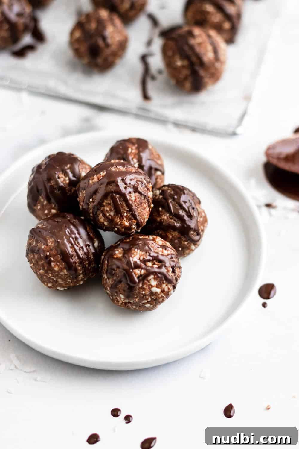 No-Bake Chocolate Coconut Date Energy Balls 2 German Chocolate Cake Balls with chocolate drizzle.