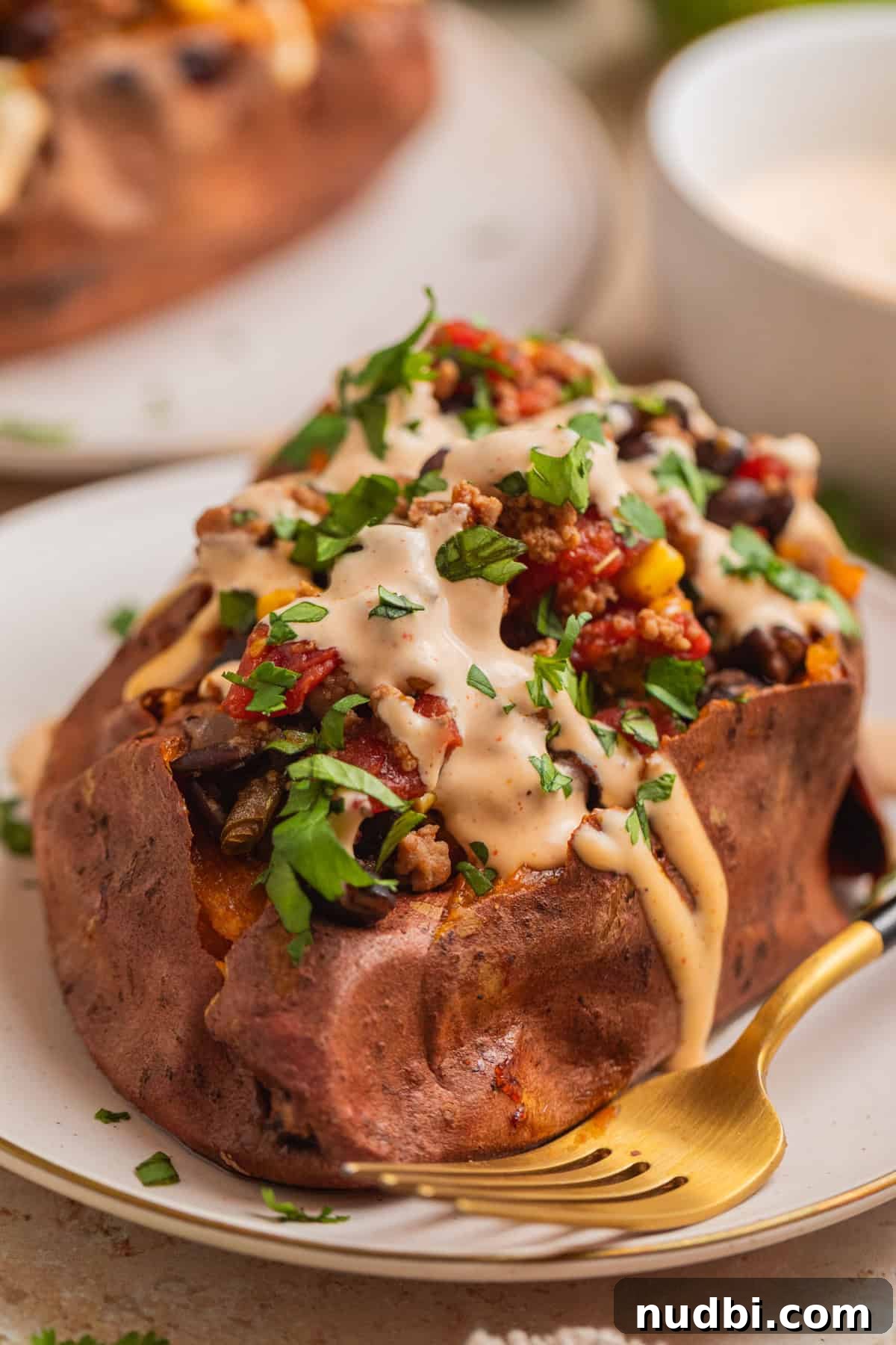 Taco-Stuffed Sweet Potatoes That Are Ready in 30 Minutes 2 Roasted sweet potato topped with ground turkey taco mixture and cream sauce.