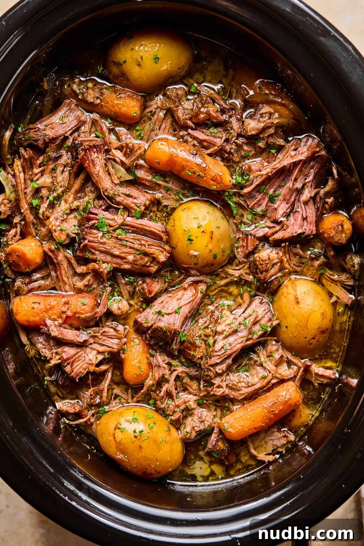 Slow-Cooked Chuck Roast Recipe for Tender, Juicy Beef 3 Crockpot with prepared chuck roast and vegetables.