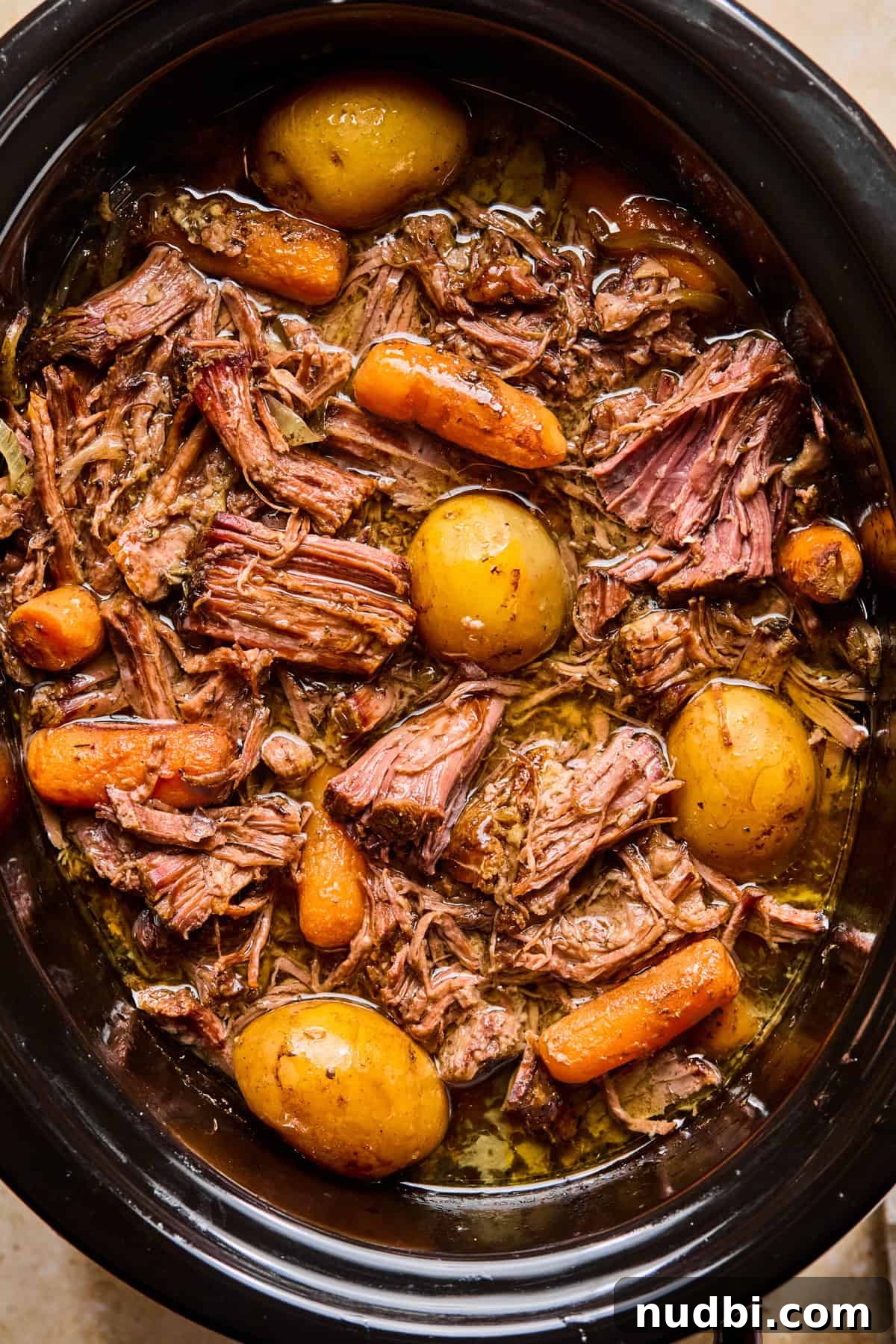 Slow-Cooked Chuck Roast Recipe for Tender, Juicy Beef 9 Chunks of meat, cooked carrots, onions and petite potatoes in slow cooker.