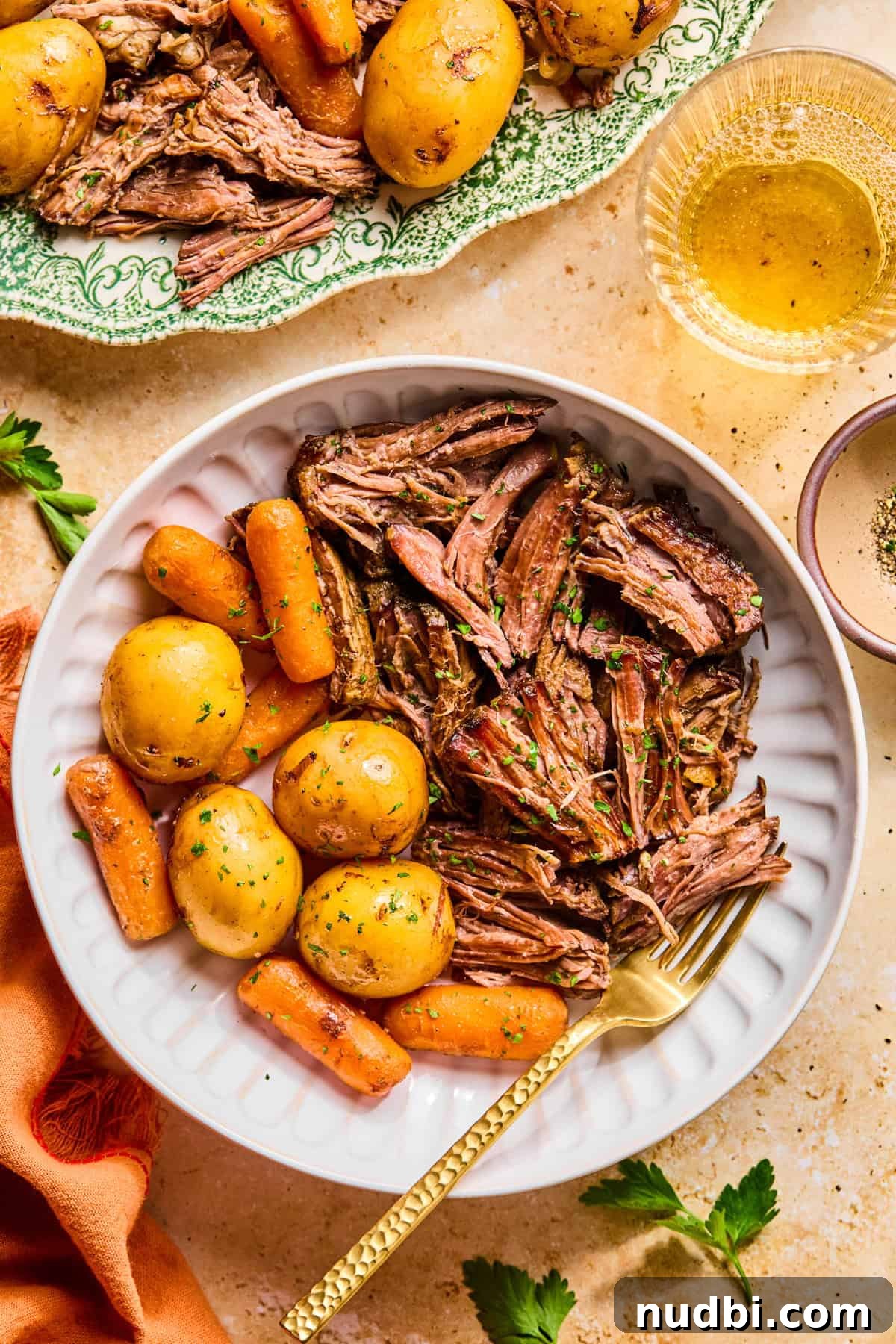 Slow-Cooked Chuck Roast Recipe for Tender, Juicy Beef 10 Plate with pot roast served and fork propped on plate.