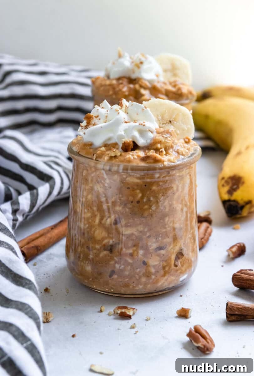 Pumpkin Banana Overnight Oats Recipe for Fall Breakfast 3 Jars of pumpkin banana overnight oats with banana, cinnamon sticks and pecans surrounding.