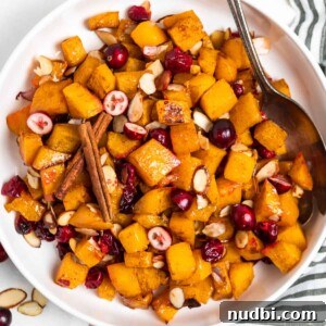 Roasted Butternut Squash with Cranberries and Almonds 3 Overhead view of white bowl with maple roasted butternut squash.