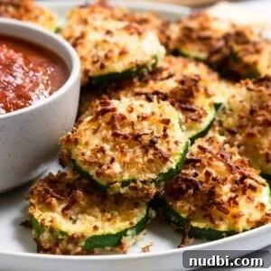Crispy Air Fryer Zucchini with Three-Cheese Coating 7 Zucchini with crispy cheese coating on plate.