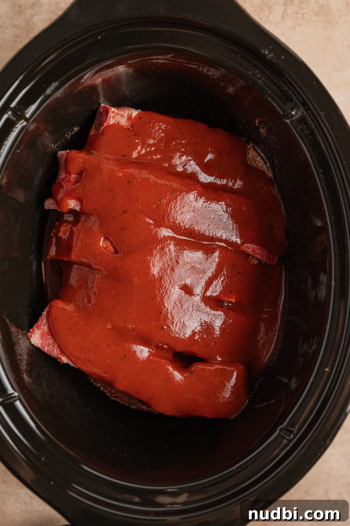 Slow-Cooker Country-Style BBQ Ribs: Tender, Fall-Off-the-Bone Recipe 7 BBQ sauce over boneless pork ribs in slow cooker.