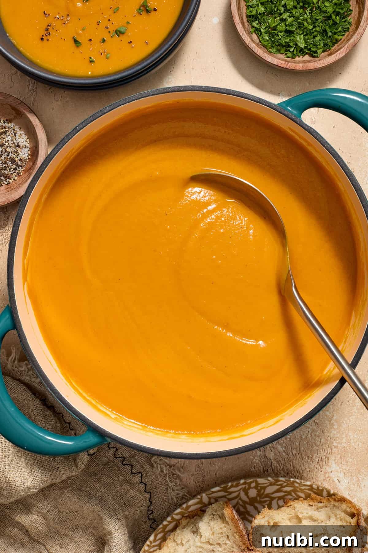 Maple-Roasted Sweet Potato and Carrot Soup Recipe 5 Pot with smooth and creamy roasted sweet potato carrot soup with ladle.