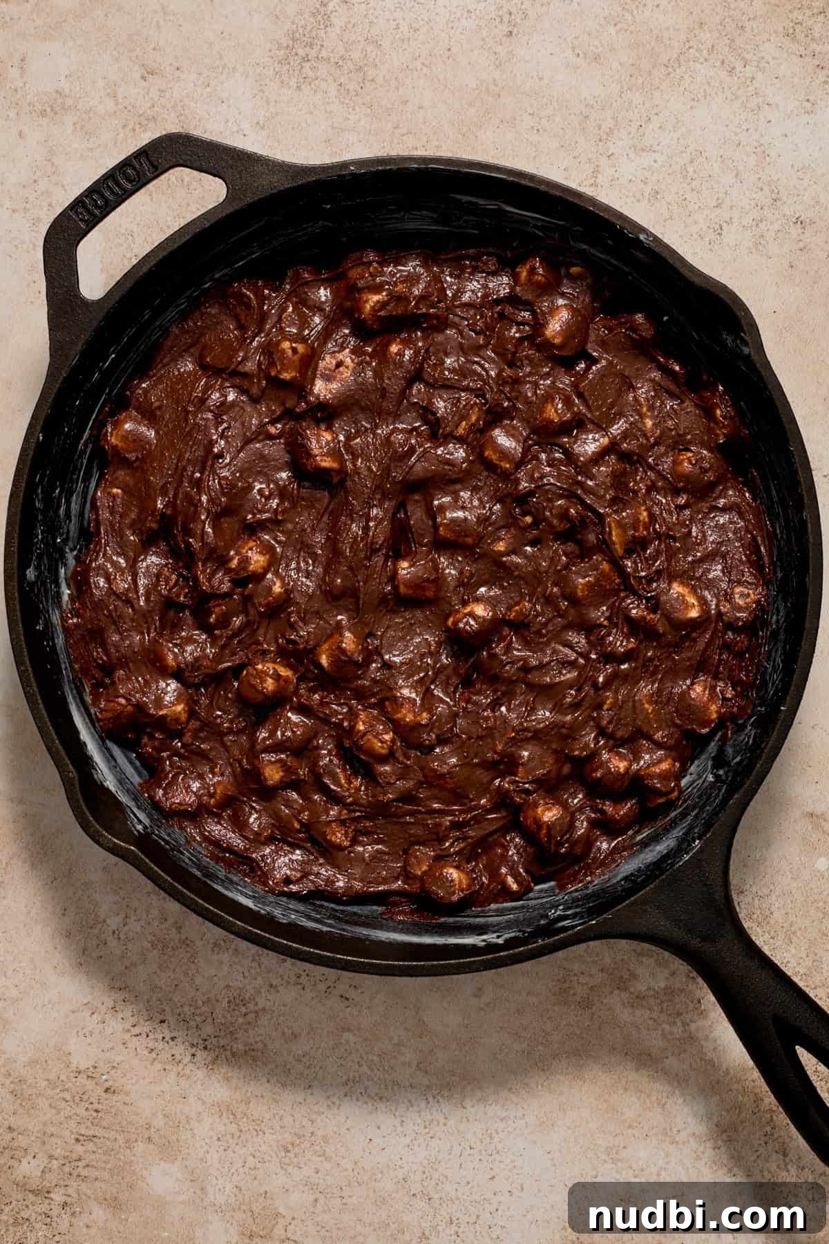 Skillet S'mores Brownie Recipe: Gooey Campfire Dessert 6 Brownie batter in cast iron skillet before baking.
