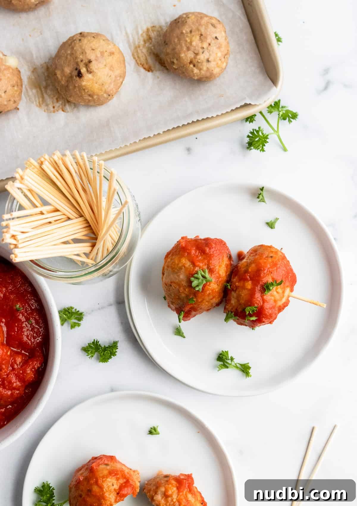 Mozzarella-Stuffed Turkey Meatballs Recipe for Juicy Bites 7 Meatballs on plate with toothpicks.