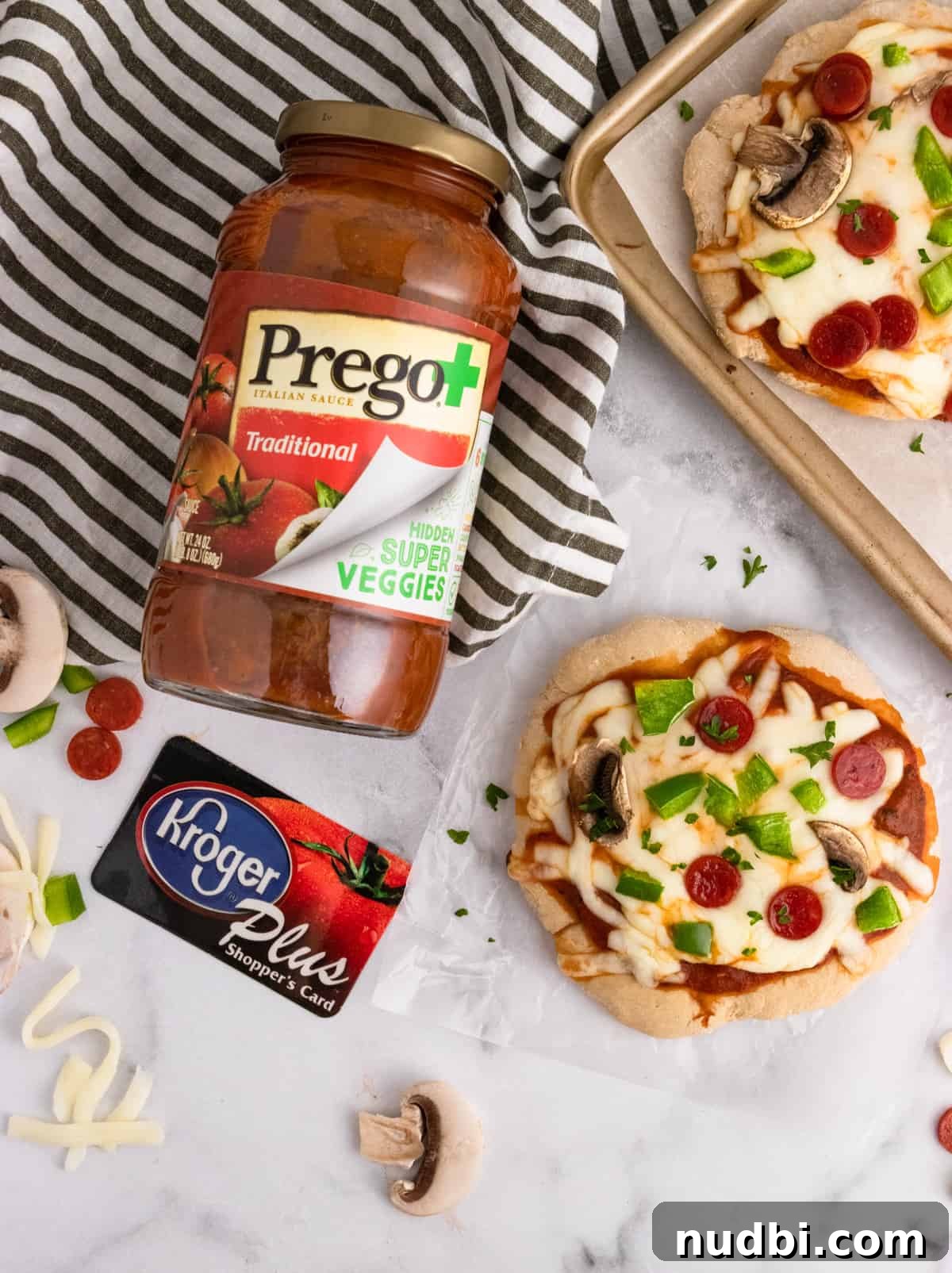 Whole Wheat Mini Veggie-Packed Pizzas for Kids 4 Prego and Kroger card with pizza on counter.