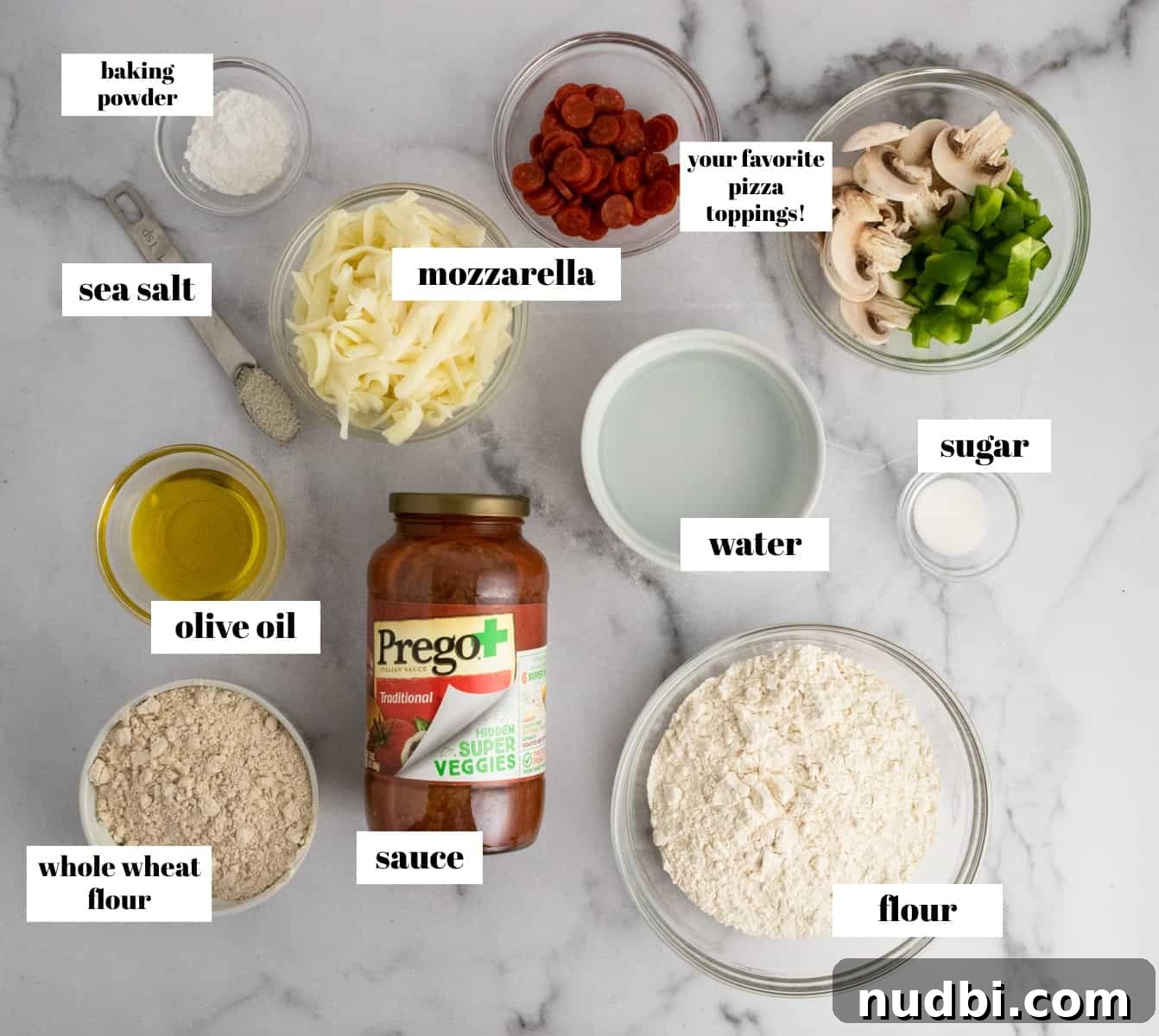 Whole Wheat Mini Veggie-Packed Pizzas for Kids 5 Pizza ingredients labeled on counter.