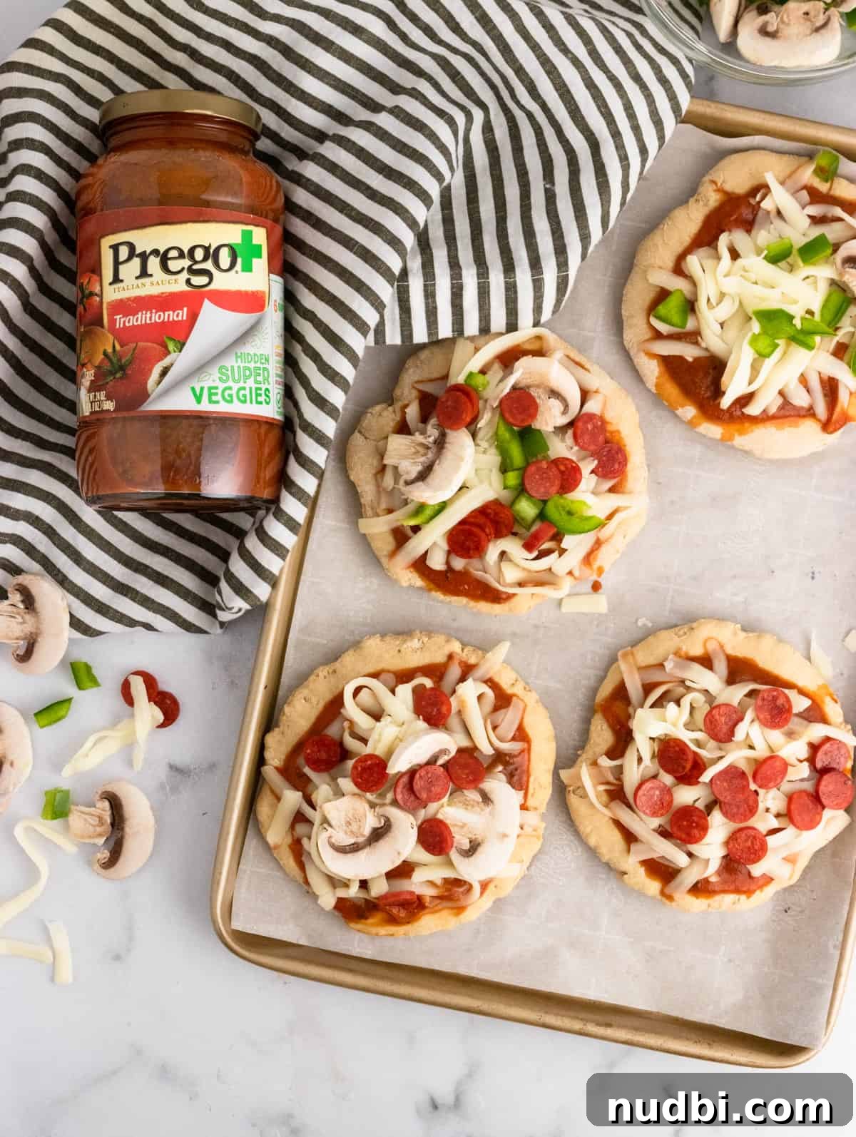 Whole Wheat Mini Veggie-Packed Pizzas for Kids 9 Pizza crust with sauce and toppings.