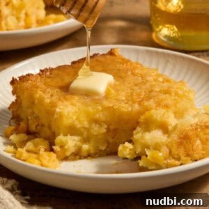 Sweet Honey Cornbread Casserole Recipe for Comforting Family Meals 13 Sweet jiffy cornbread casserole on plate with honey drizzling over top.