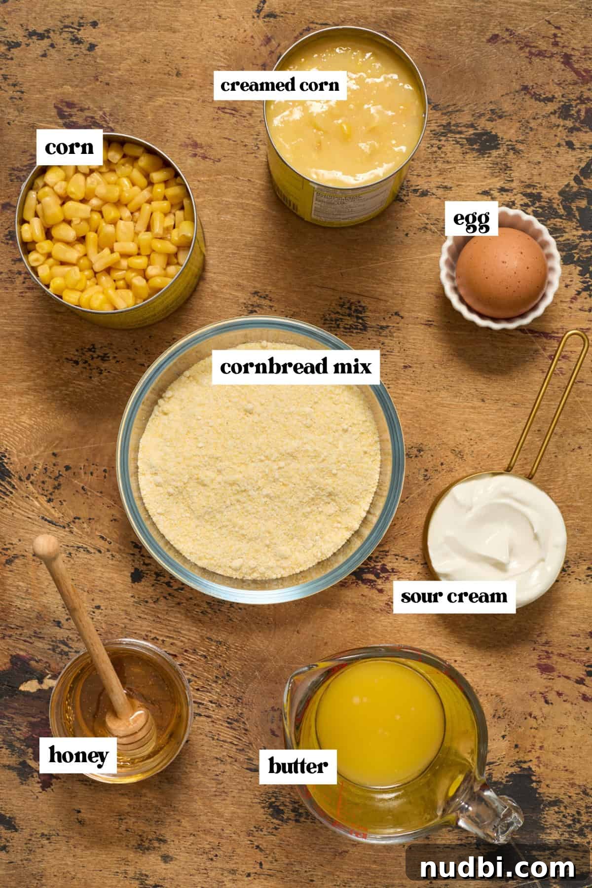 Sweet Honey Cornbread Casserole Recipe for Comforting Family Meals 4 Cornbread mix, honey, creamed corn and other ingredients arranged on surface.