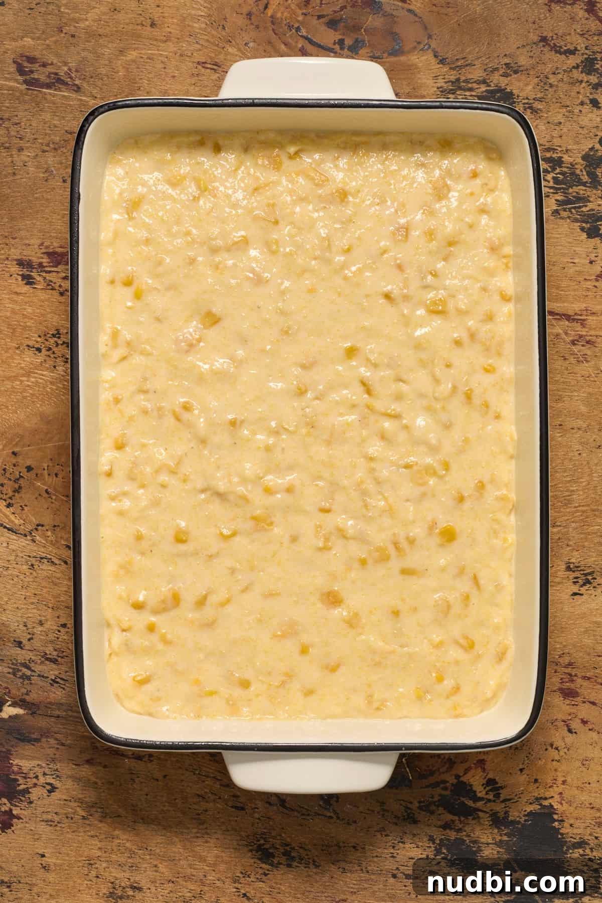 Sweet Honey Cornbread Casserole Recipe for Comforting Family Meals 9 Casserole dish with jiffy sweet cornbread casserole before baked.