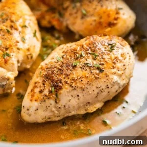 Simple White Wine Chicken Recipe for Weeknight Dinners 8 Seared chicken breast in skillet in buttery white wine sauce.