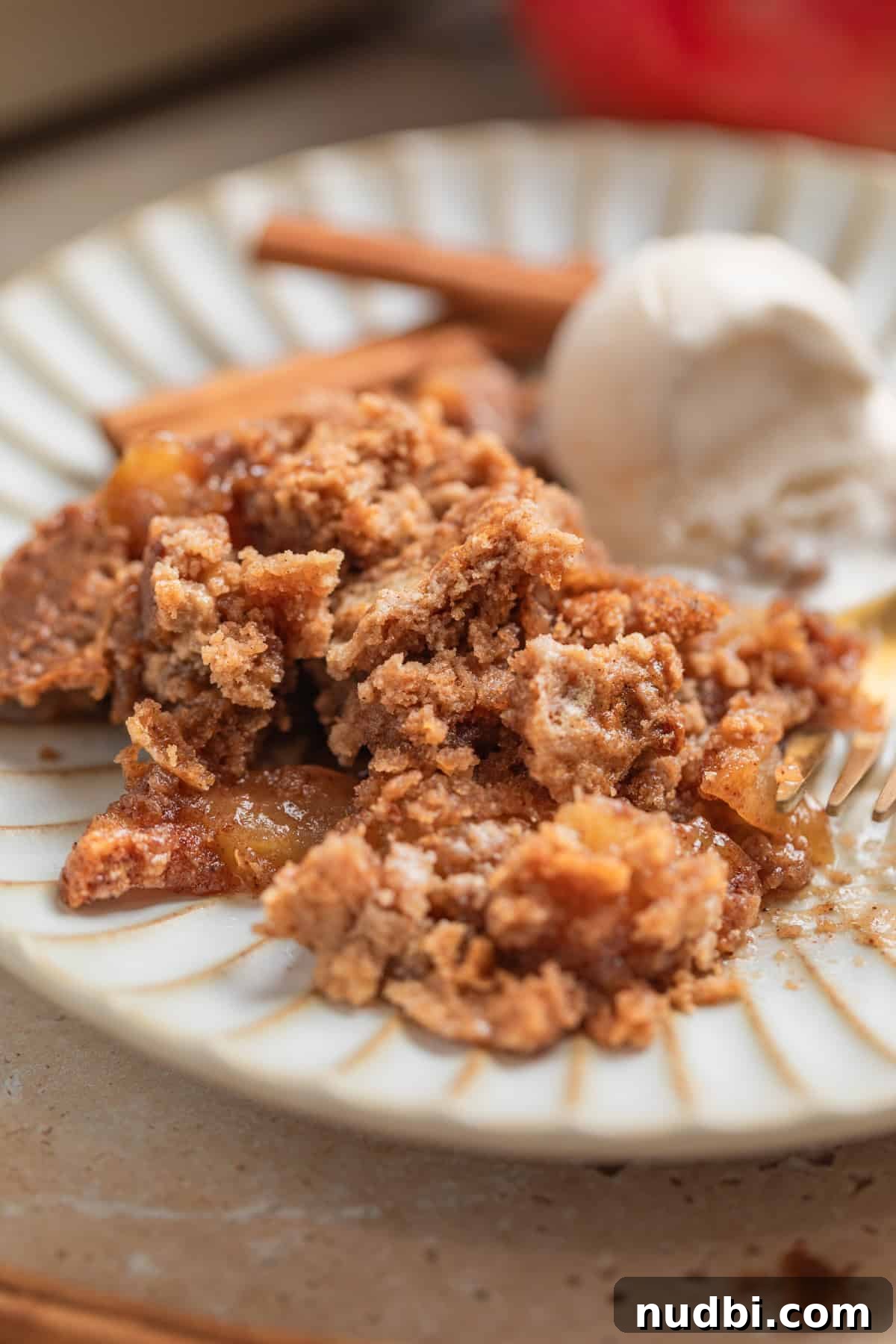 Classic Apple Dump Cake Recipe: Quick Homemade Comfort Dessert 8 Serving of apple recipe on plate with ice cream and fork.