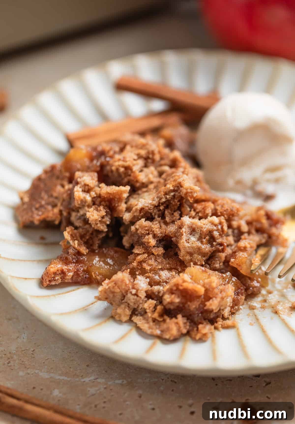 Classic Apple Dump Cake Recipe: Quick Homemade Comfort Dessert 3 Cinnamon apple dump cake recipe served on dish with vanilla ice cream.