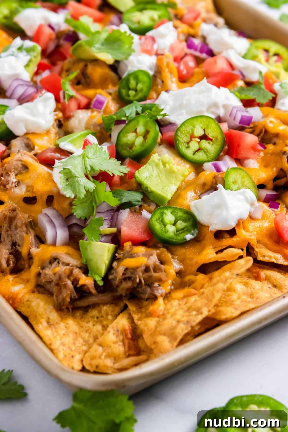 Ultimate Pulled Pork Nachos Recipe for Game Day Crowd 2 Pulled pork nachos on sheet pan.