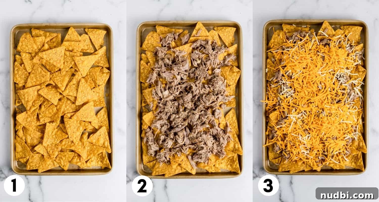 Ultimate Pulled Pork Nachos Recipe for Game Day Crowd 4 Nachos on sheet pan with pork and cheese.