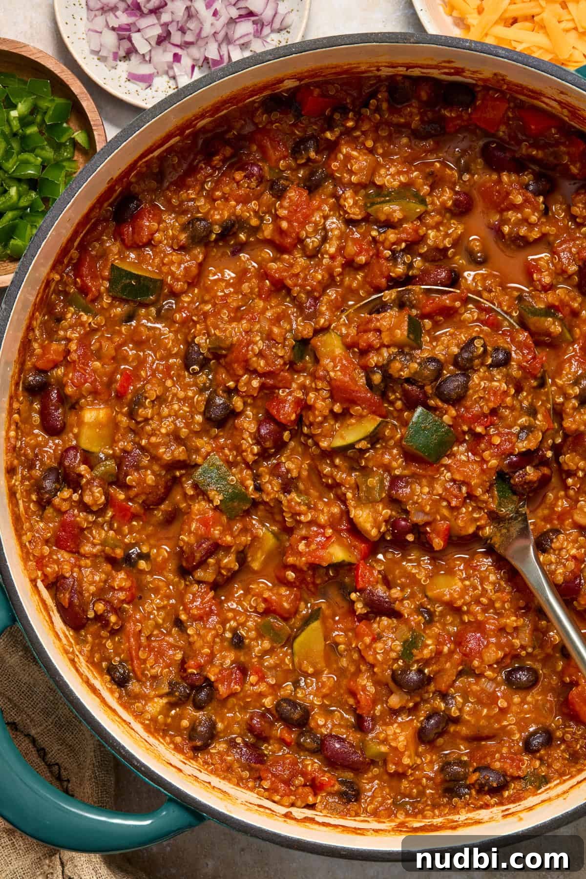 Hearty Pumpkin Quinoa Chili Recipe for Fall Nights 2 Pot with pumpkin quinoa chili with ladle.