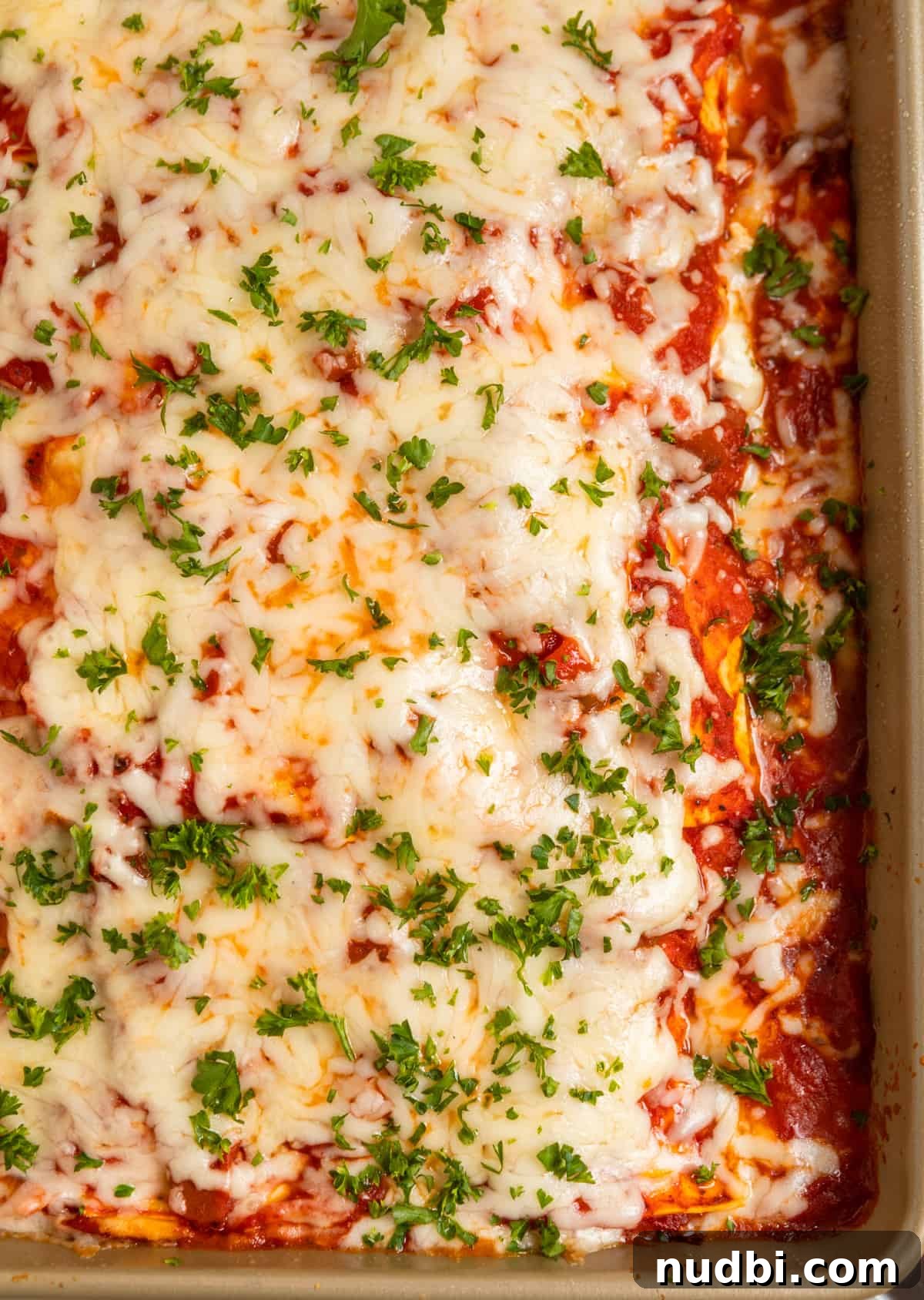 No-Boil Lasagna Recipe: Quick, Cheesy Oven-Baked Lasagna 8 Pan with no boil lasagna topped with fresh parsley.