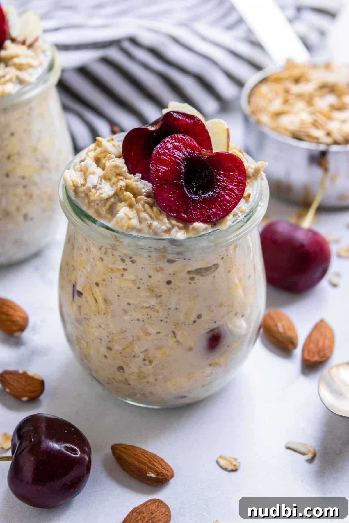 Creamy Vegan Overnight Oats Recipe for Quick Plant-Based Breakfast 2 Oatmeal in a jar with cherry slices.