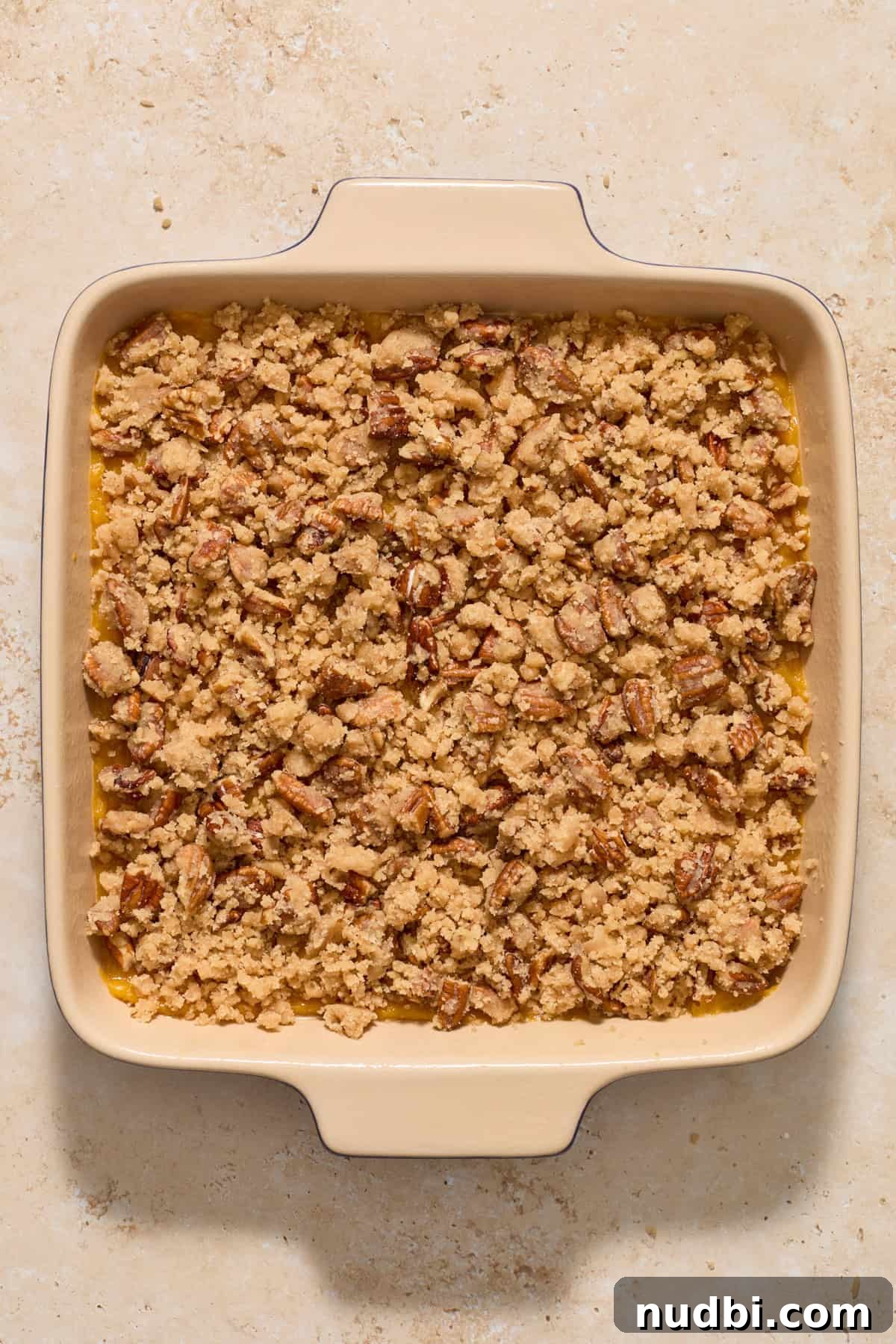 Creamy Butternut Squash Casserole with Sage and Parmesan 7 Butternut squash casserole ingredients in baking pan before being baked.
