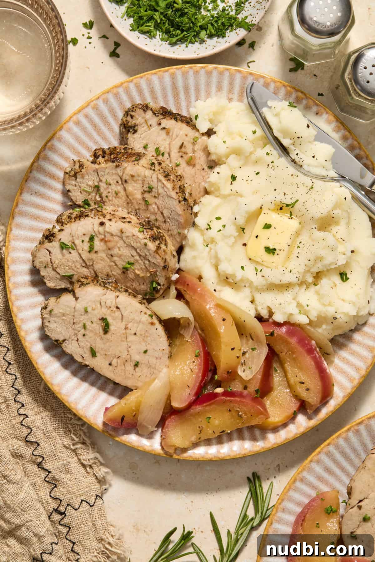 Juicy Instant Pot Pork Tenderloin Recipe for Quick Dinners 2 Plate with instant pot pork tenderloin, cooked apples and mashed potatoes.