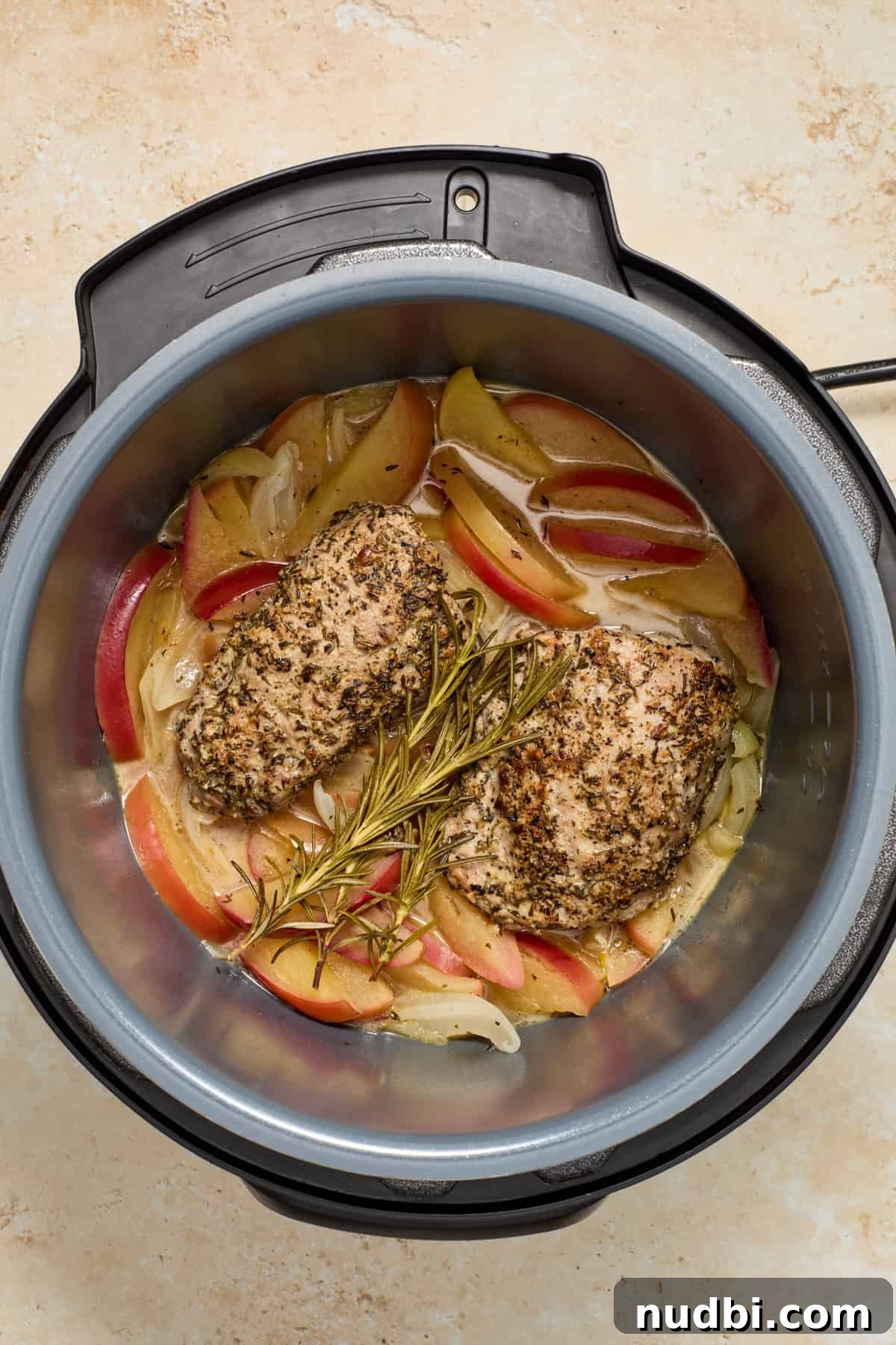 Juicy Instant Pot Pork Tenderloin Recipe for Quick Dinners 11 Cooked pork tenderloin and apples in Instant pot pressure cooker.