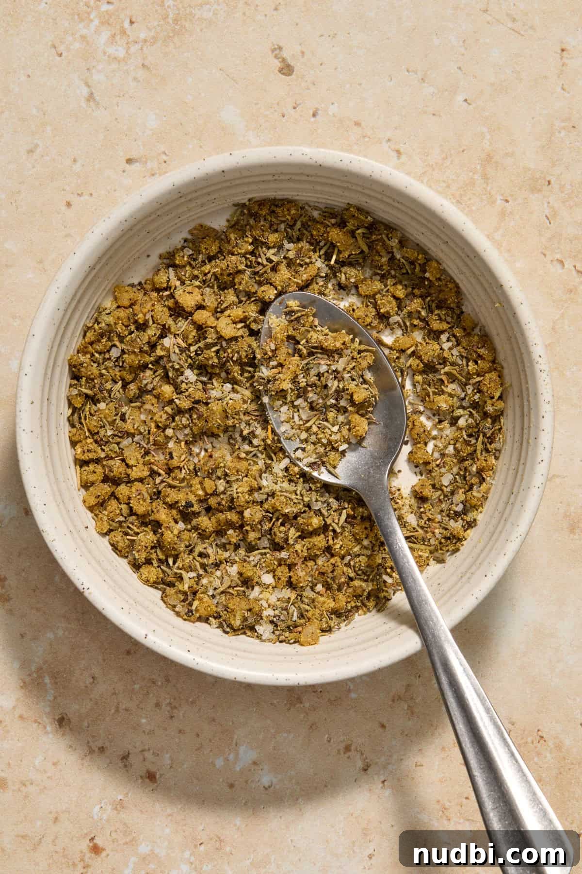 Juicy Instant Pot Pork Tenderloin Recipe for Quick Dinners 5 Seasonings mixed together in bowl with spoon.