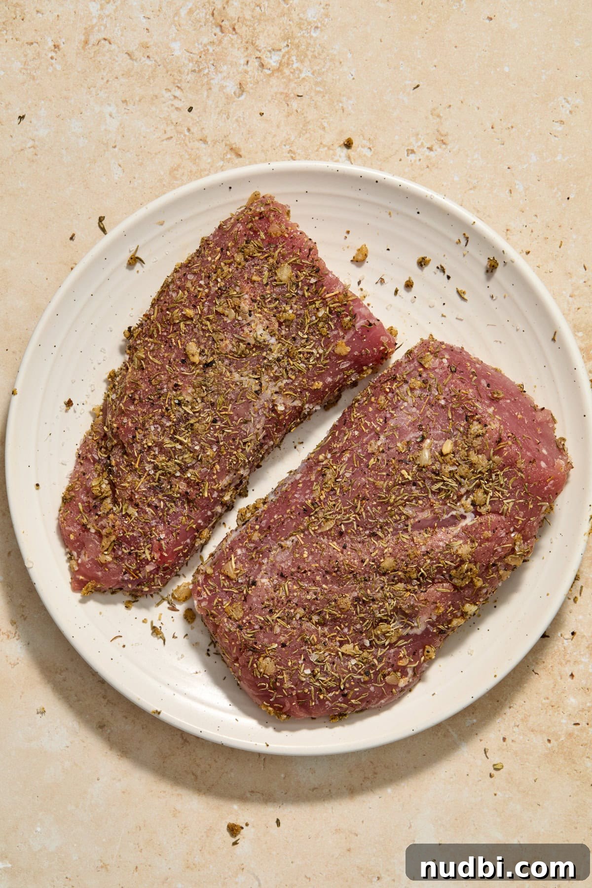Juicy Instant Pot Pork Tenderloin Recipe for Quick Dinners 6 Seasoned pork tenderloin on plate.